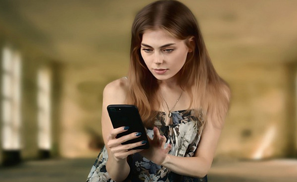 young woman looking at something on her cell phone
